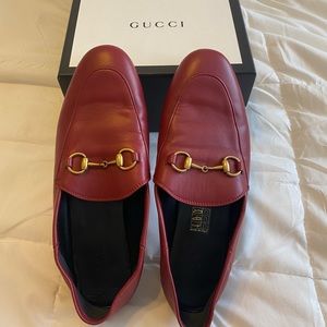 Red Gucci loafers.